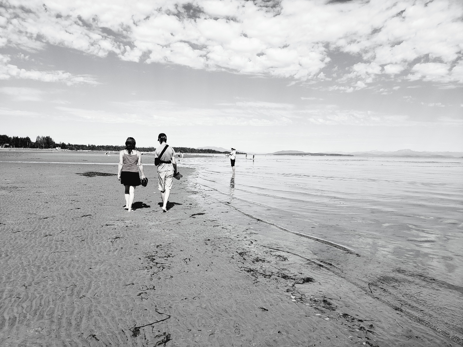 Photo of mom and son walking together on beach
