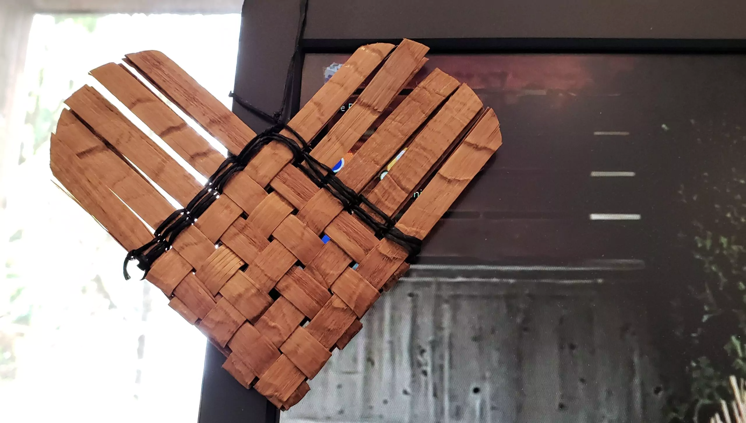 Photograph of a heart ornament of woven cedar strips