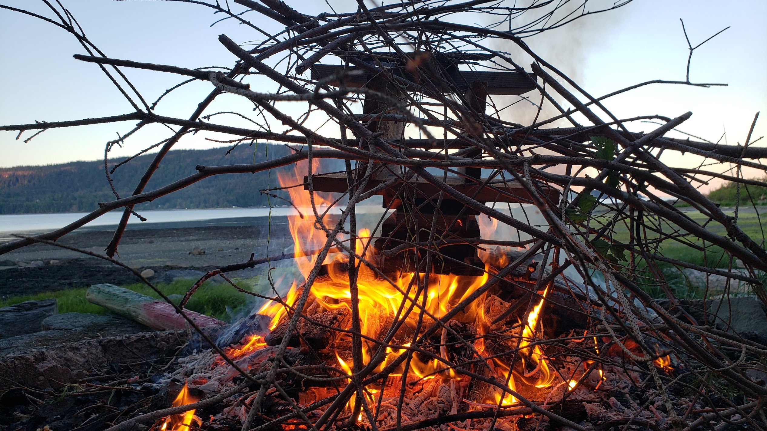 Photo of outdoor campfire featuring artistically-styled sticks